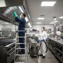 Cleaner working at height on ceilings and light fittings
