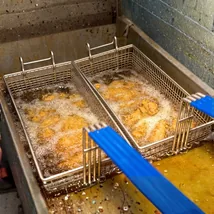 Technician deep cleaning a commercial kitchen canopy