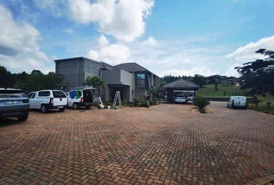 Cleaning Specialists vehicles on site for window cleaning at a residential estate home