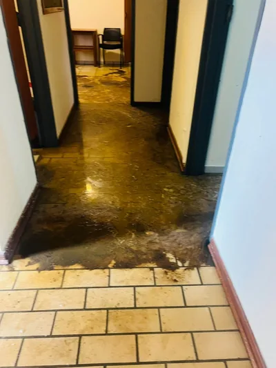 Sewage flooded office corridor before emergency deep clean